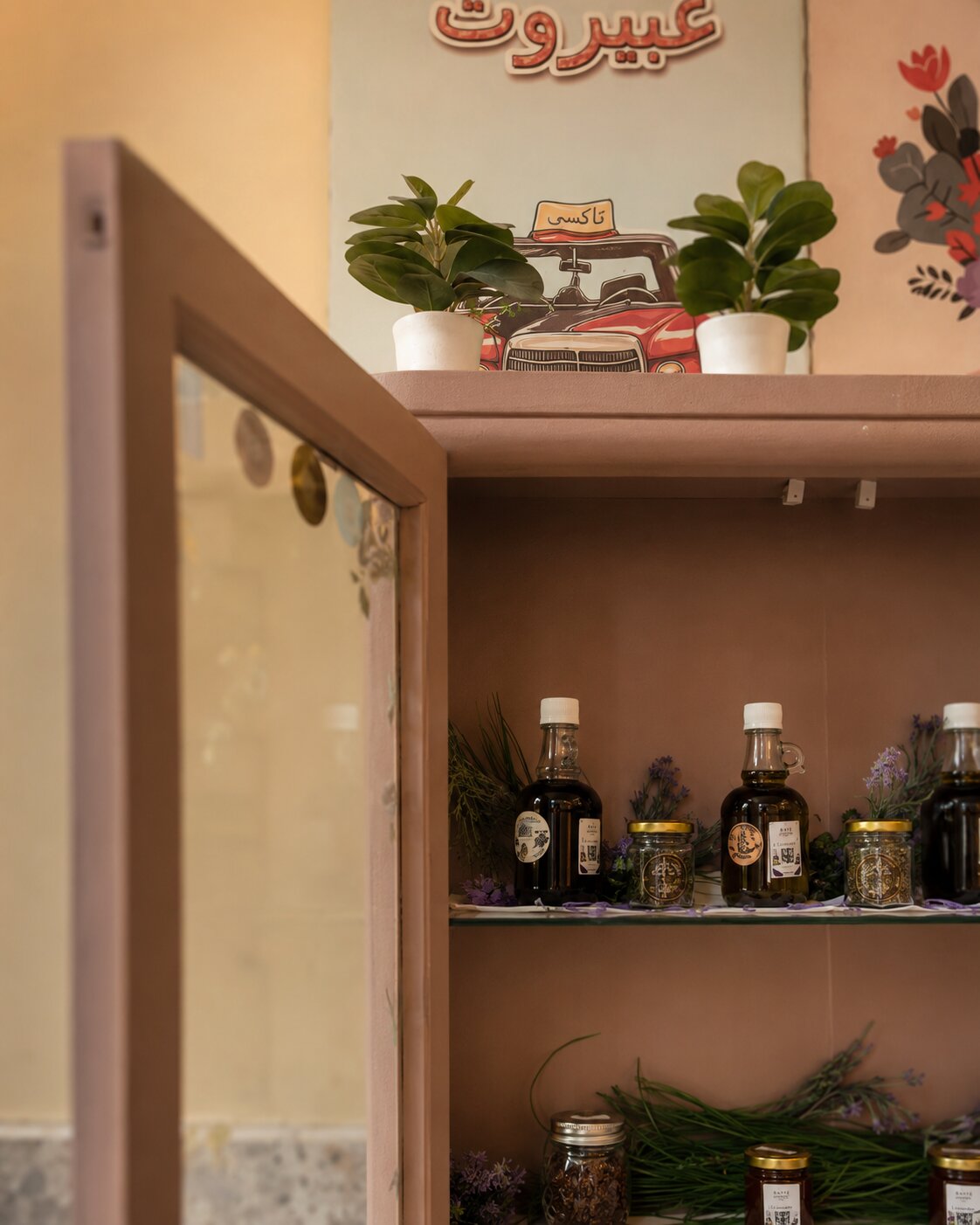 Bayté Boutique — the open cabinet seen from the side, JARN bottles and jars on the shelves